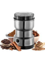 Stainless steel coffee grinder with coffee beans, ground coffee, and spices on a white background